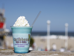 blue drink with whipped cream, blurred background of the beach and ocean
